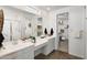 Modern bathroom featuring double sinks, a spacious walk-in shower, and a well-organized walk-in closet at 25120 N 174Th Ave, Surprise, AZ 85387