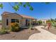 Beautiful backyard featuring a covered patio, desert landscaping, and a winding stone pathway at 26288 W Horsham Ct, Buckeye, AZ 85396