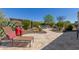 Beautiful backyard featuring a fire pit, desert landscaping, and a lounge chair for relaxation at 26288 W Horsham Ct, Buckeye, AZ 85396