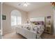 Cozy bedroom with a white frame bed, ceiling fan, and window with shutters at 26288 W Horsham Ct, Buckeye, AZ 85396