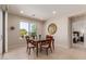 Elegant dining room with natural light, a stylish table set, and easy access to outdoor views at 26288 W Horsham Ct, Buckeye, AZ 85396