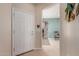 Bright entryway with tile flooring and white front door, decorated with stylish wall accents at 26288 W Horsham Ct, Buckeye, AZ 85396