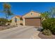 Front exterior showing a desert landscaped front yard, two-car garage, and tile roof at 26288 W Horsham Ct, Buckeye, AZ 85396