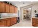 Cozy kitchen with granite counters, stainless steel wine cooler, and sliding door to patio at 26288 W Horsham Ct, Buckeye, AZ 85396