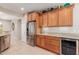 Bright kitchen featuring granite countertops, stainless steel refrigerator, and wine cooler at 26288 W Horsham Ct, Buckeye, AZ 85396