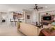 Spacious living room with kitchen view, offering seamless flow and integrated living spaces at 26288 W Horsham Ct, Buckeye, AZ 85396