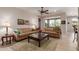 Comfortable living room with neutral tones, ceiling fan, and a view to the outdoor greenery at 26288 W Horsham Ct, Buckeye, AZ 85396