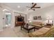 Cozy living room with ceiling fan, stylish furniture, and a seamless transition to other living spaces at 26288 W Horsham Ct, Buckeye, AZ 85396