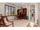 Bright home office with wood desk, built-in shelving, and large window with shutters at 26288 W Horsham Ct, Buckeye, AZ 85396