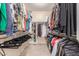 Walk-in closet with ample hanging space, shelving, and shoe storage at 26288 W Horsham Ct, Buckeye, AZ 85396