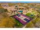 Aerial view showcasing a luxury property with a pool, putting green, sports court, and covered outdoor living space at 27632 N 68Th Pl, Scottsdale, AZ 85266