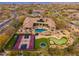 Aerial view showcases a pool with grotto, putting green, trampoline, and basketball court at 27632 N 68Th Pl, Scottsdale, AZ 85266