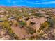 Overhead shot of an estate boasting a sprawling layout, beautiful desert landscaping, and mountain views at 27632 N 68Th Pl, Scottsdale, AZ 85266