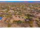 Aerial view shows estate with pool, putting green, and basketball court amid desert landscape at 27632 N 68Th Pl, Scottsdale, AZ 85266