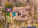 Overhead view of a private estate featuring a pool, sports court, trampoline, putting green, and desert landscaping at 27632 N 68Th Pl, Scottsdale, AZ 85266