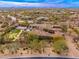 Aerial view of an estate with a private putting green and basketball court and a stunning mountain backdrop at 27632 N 68Th Pl, Scottsdale, AZ 85266