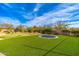 A spacious backyard featuring artificial turf, a putting green, and a trampoline, perfect for outdoor fun at 27632 N 68Th Pl, Scottsdale, AZ 85266