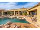 An inviting backyard showcases a sparkling pool, comfortable lounge chairs, and a stylish exterior of the home at 27632 N 68Th Pl, Scottsdale, AZ 85266