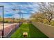 Outdoor sports court, grassy area, and desert landscaping create a versatile and inviting backyard space at 27632 N 68Th Pl, Scottsdale, AZ 85266