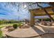 Expansive backyard showcasing a putting green, a rock waterfall, a pool, a sports court, and desert landscaping at 27632 N 68Th Pl, Scottsdale, AZ 85266