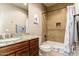 Bathroom vanity with granite countertop, tub and shower with neutral tile at 27632 N 68Th Pl, Scottsdale, AZ 85266