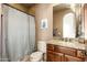 Bathroom with granite countertops, wooden vanity, neutral walls and shower with pattern curtain at 27632 N 68Th Pl, Scottsdale, AZ 85266