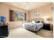 Bedroom featuring neutral walls, a large window and a metal frame bed with colorful pillows at 27632 N 68Th Pl, Scottsdale, AZ 85266