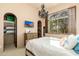 Bright bedroom with ensuite closet, wooden dresser, and shuttered window at 27632 N 68Th Pl, Scottsdale, AZ 85266