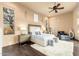 Serene bedroom with neutral tones, a ceiling fan, and hardwood floors exudes relaxation at 27632 N 68Th Pl, Scottsdale, AZ 85266