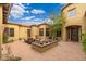 Private courtyard with a charming fountain, seating area, and manicured landscaping at 27632 N 68Th Pl, Scottsdale, AZ 85266