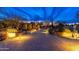 Long, private brick driveway leading to a stunning desert home with illuminated landscaping at 27632 N 68Th Pl, Scottsdale, AZ 85266