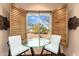 Dining area features a clear table and two chairs with a beautiful backyard view at 27632 N 68Th Pl, Scottsdale, AZ 85266