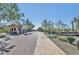 Community entrance with gatehouse, mature desert landscaping, and paved driveway, adding exclusivity and curb appeal at 27632 N 68Th Pl, Scottsdale, AZ 85266