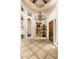 Grand foyer with tiled floors, soaring ceilings, arched doorways, and an elegant chandelier at 27632 N 68Th Pl, Scottsdale, AZ 85266