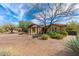 Charming estate entrance with a pergola, stone pillars, desert landscaping, and a brick driveway at 27632 N 68Th Pl, Scottsdale, AZ 85266