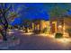 Inviting entrance with stone accents, lush landscaping, and a paver driveway leading to this desert home at 27632 N 68Th Pl, Scottsdale, AZ 85266