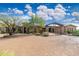 Attractive desert home with a circular brick driveway, porte-cochere, and lush desert landscaping at 27632 N 68Th Pl, Scottsdale, AZ 85266