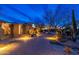 Stunning desert home with a paved driveway and professional lighting enhancing the landscape at twilight at 27632 N 68Th Pl, Scottsdale, AZ 85266