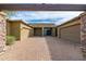 Desert home featuring a spacious three-car garage and a brick driveway and desert landscaping at 27632 N 68Th Pl, Scottsdale, AZ 85266