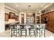 Kitchen island featuring granite countertops, a decorative chandelier, and seating for four at 27632 N 68Th Pl, Scottsdale, AZ 85266