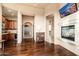 Open-concept living room features a fireplace and arched doorways leading to other rooms at 27632 N 68Th Pl, Scottsdale, AZ 85266