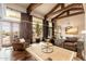 Open-concept living room with beamed ceilings, large windows, and inviting seating area at 27632 N 68Th Pl, Scottsdale, AZ 85266