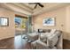 Bright living room with plush gray sectional sofa and outdoor patio access with desert view at 27632 N 68Th Pl, Scottsdale, AZ 85266