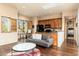 Living room features a mini kitchen, sofa, and a window with shutters at 27632 N 68Th Pl, Scottsdale, AZ 85266