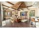 Bright, open living room showcasing wood beam ceilings, a fireplace, and a leather sofa set at 27632 N 68Th Pl, Scottsdale, AZ 85266