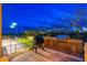 Outdoor kitchen with a built-in BBQ grill and lush landscaping, adjacent to a tennis court at 27632 N 68Th Pl, Scottsdale, AZ 85266