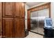 Pantry with plenty of storage, dark wood cabinets, and a stainless steel refrigerator at 27632 N 68Th Pl, Scottsdale, AZ 85266