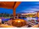 Covered patio with outdoor fire pit and scenic sunset view at 27632 N 68Th Pl, Scottsdale, AZ 85266