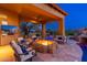 Cozy outdoor fireplace and seating on covered patio adjacent to the resort style pool at 27632 N 68Th Pl, Scottsdale, AZ 85266