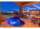 Backyard pool with a hot tub, water slide, and covered patio at 27632 N 68Th Pl, Scottsdale, AZ 85266